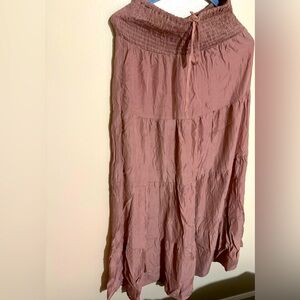 Long ruffle skirt it’s like a taupe color not too sure